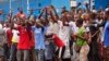 Residents from an area close to the West Point Ebola center, protest as they are not allowed to enter the area leading to their homes in Monrovia, Liberia, Aug. 20, 2014.