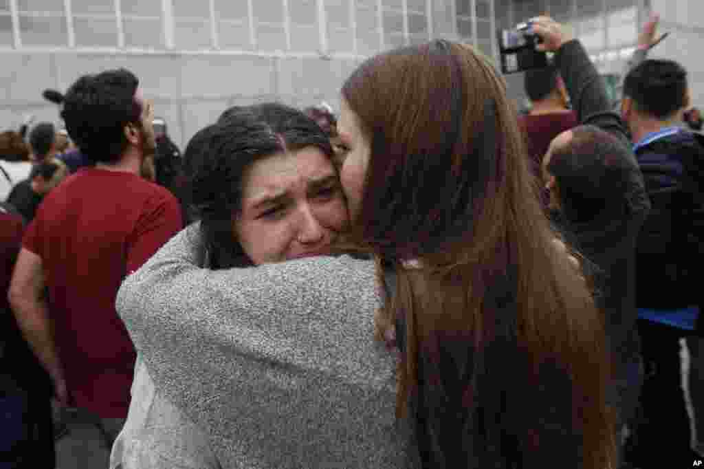 A woman cries after civil guards dragged people away from the entrance of a sports center, assigned to be a referendum polling station by the Catalan government in Sant Julia de Ramis, near Girona, Oct. 1, 2017.