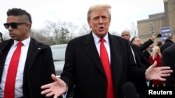 Former U.S. President and Republican presidential candidate Donald Trump speaks as he makes a visit to a polling station on election day in the New Hampshire presidential primary, in Londonderry, New Hampshire, Jan. 23, 2024. 