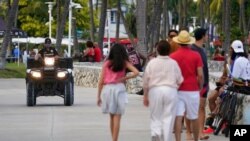 A police officer on an ATV patrols in Florida's famed South Beach, March 22, 2021. 