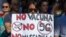 FILE - Demonstrators attend a protest against nationwide restrictions against COVID-19 in Madrid, Spain, Aug. 16, 2020. A banner reads in Spanish 'No vaccine No 5G No mask'.
