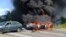 Two police cars ablaze at the site of unrest in Mukhachevo, Western Ukraine, July 11, 2015.