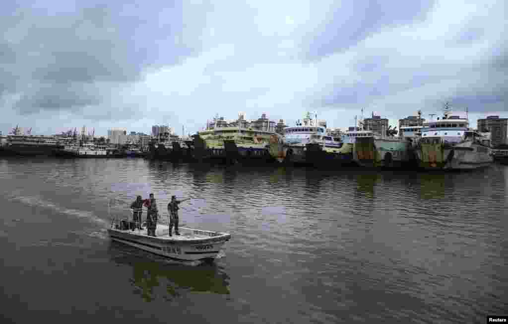 Chinese coast guards patrol on a boat as ships are docked in the port before the landfall of Typhoon Rammasun, at a port in Haikou, Hainan, province July 17, 2014.