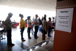FILE - People stand in line to buy tickets for daytime-only screenings of the Kenyan movie "Rafiki" at the Prestige Cinema after a judge temporarily lifted a ban on the film in Nairobi, Kenya, Sept. 24, 2018.