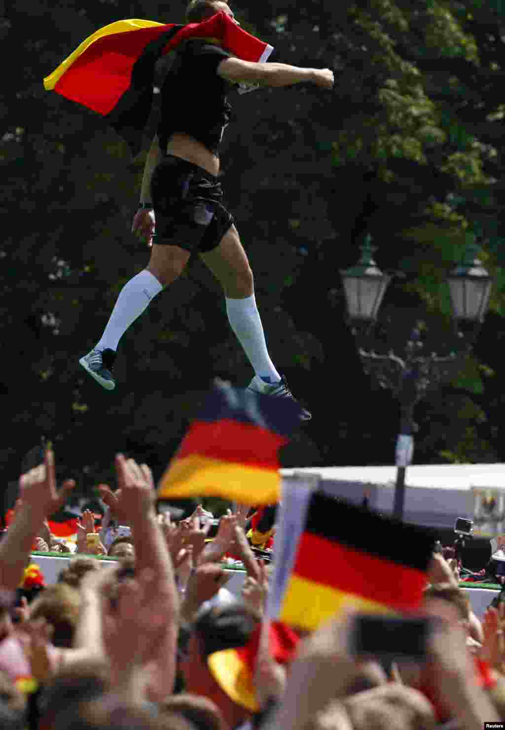 Germany&#39;s goalkeeper Manuel Neuer jumps in the air during celebrations to mark the team&#39;s 2014 Brazil World Cup victory, at the Fan Mile public viewing zone, in Berlin, July 15, 2014.