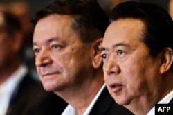 FILE - Interpol vice president Alexander Prokopchuk (L) and Meng Hongwei, then-president of Interpol, are seen at the opening of the Interpol World Congress, in Singapore, July 4, 2017.