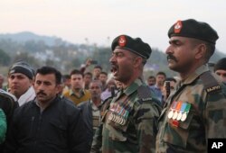 FILE - Indian army soldiers pay tribute to a colleague killed in cross-border firing with Pakistan, during his cremation at Nachlah village in Samba District of Jammu and Kashmir, India, Feb.5, 2018.