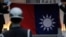 FILE - Honor guards lower a Taiwanese flag at Liberty Square, in Taipei, Taiwan, April 1, 2020.