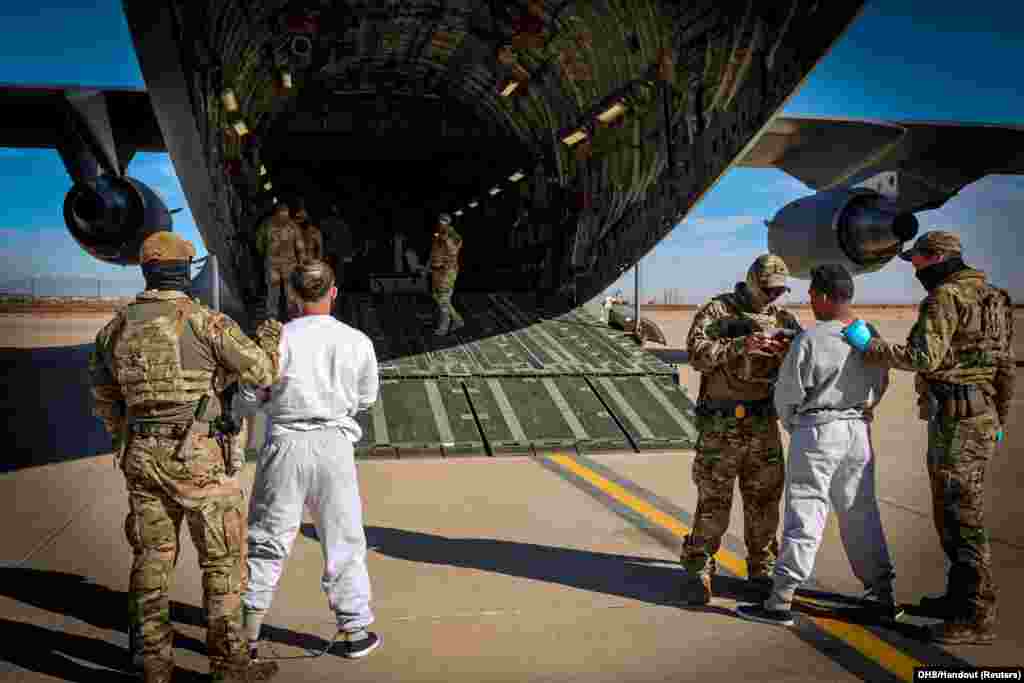 The first U.S. military aircraft to carry detained migrants whom U.S. Department of Homeland Security spokesperson Tricia McLaughlin called &quot;highly dangerous criminal aliens,&quot; to a detention center at Guantanamo Bay, Cuba, is boarded from an unidentified site in the U.S. on February 4, 2025.