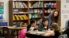 Chelsea Duvenez, upper right, works with students in her fourth-grade classroom at Olympic View Elementary School, Friday, March 9, 2018, in Lacey, Wash. (AP Photo/Ted S. Warren)