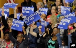 Supporters react to positive primary results for Democratic presidential candidate Hillary Clinton before a rally at Cuyahoga Community College in Cleveland, March 8, 2016.