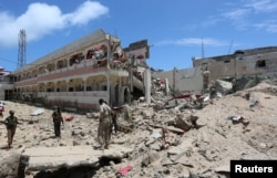 Security forces stand at the SYL hotel that was partly destroyed following a car bomb claimed by al Shabab Islamist militants outside the president's palace in the Somali capital of Mogadishu, August 30, 2016.