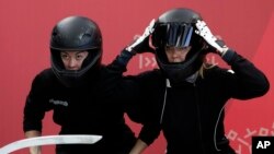 Russia's Nadezhda Sergeeva, left, and Anastasia Kocherzhova prepare to start during the women's bobsled training run at the 2018 Winter Olympics in Pyeongchang, South Korea, Feb. 18, 2018.