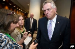 National Governors Association (NGA) Chairman Gov. Terry McAuliffe speaks with reporters after leaving a health care reform meeting during the NGA's Winter Meeting in Washington, Saturday, Feb. 25, 2017.