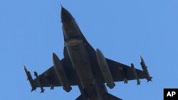 FILE - A missile-loaded Turkish Air Force jet after taking off from Incirlik Air Base, in Adana, southern Turkey, July 29, 2015. 