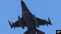 FILE - A missile-loaded Turkish Air Force jet after taking off from Incirlik Air Base, in Adana, southern Turkey, July 29, 2015. 
