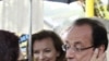 Socialist Party candidate for the presidential election Francois Hollande meets a resident with his companion Valerie Trierweiler, center, as he tours Tulle, after voting , May 6, 2012. 