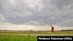 Buddhist monk Sutham Nateetong walks along the road outside Arcola, IN. June 8, 2019.