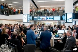Washington Post National Politics Deputy Editor Peter Wallsten, center left, accompanied by National Security Editor Peter Finn, center right, and Executive Editor Marty Baron, right, speaks to the newsroom after The Washington Post wins two pulitzer prizes, April 16, 2018, in Washington.