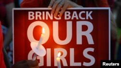 People participate in a "Bring Back Our Girls" campaign demonstration and candlelight vigil, held on Mother's Day in Los Angeles, May 11, 2014.