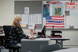 Sue Ziel, a sixth grade social studies teacher at Romeo Middle School, works in her classroom in Romeo, Mich., Tuesday, April 27, 2021. (AP Photo/Paul Sancya)