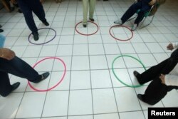 FILE - Patients with Alzheimer's and dementia are seen during a therapy session inside the Alzheimer foundation in Mexico City, April 19, 2012.