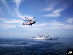 រូបភាព​ឯកសារ៖ នាវា​ឆ្មាំ​សមុទ្រ​ជប៉ុន​ និង​ឧទ្ធម្ភាគចក្រ​របស់​ភ្នាក់ងារ​អនុវត្ត​ច្បាប់​សមុទ្រ​ម៉ាឡេស៊ី​ធ្វើ​សមយុទ្ធ​រួម​មួយ​នៅ​ក្បែរ​ក្រុង Kuantan ប្រទេស​ម៉ាឡេស៊ី កាលពី​ថ្ងៃទី២៩ ខែមករា ឆ្នាំ២០១៨។