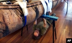 Master canoe builder Steve Cayard prepares one of the oldest-known Native American birch-bark canoes, dated from the mid-1700's, to be displayed at the Pejepscot Museum & Research Center in Brunswick, Maine, Oct. 5, 2017.