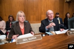 Sen. Patty Murray, D-Wash., and Sen. Lamar Alexander, R-Tenn., meet before the start of a hearing on Capitol Hill in Washington, Oct. 18, 2017.