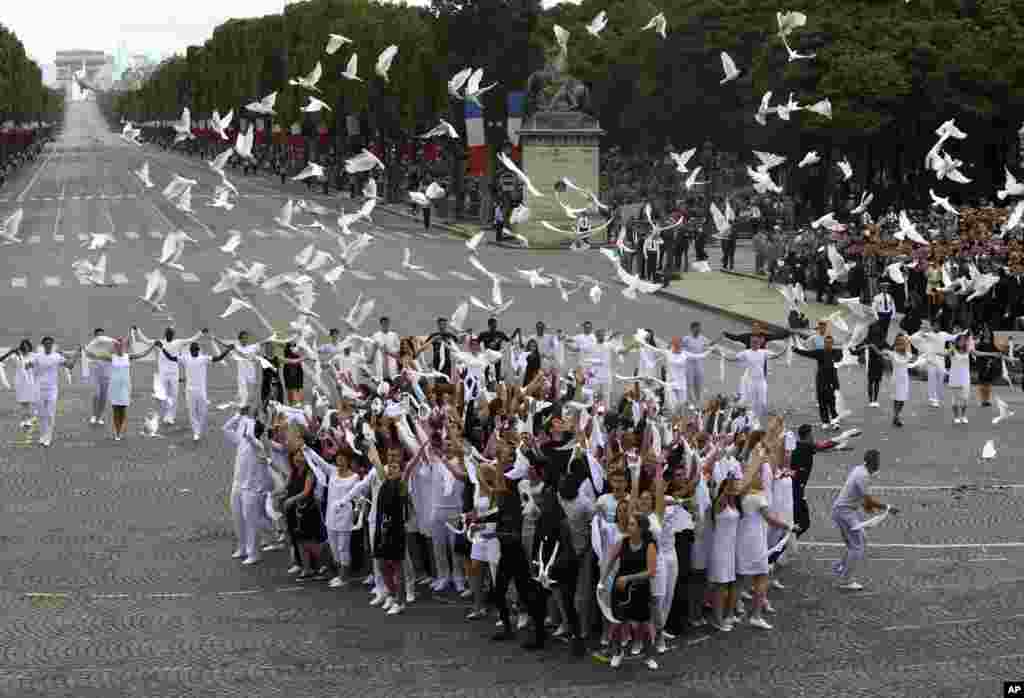 Dozens of doves are released after the Bastille Day parade in Paris, France, July 14, 2014.