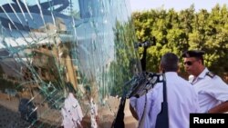 A damaged bus is seen at the site of a blast near a new museum being built close to the Giza pyramids in Cairo, Egypt, May 19, 2019. 