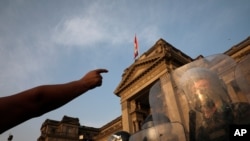Police form a cordon in front of the Justice Palace as people who are refusing to recognize the new government arrive, in Lima, Peru, Nov. 11, 2020. 