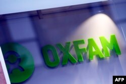 FILE - An Oxfam logo is seen on one of the organization's bookshops in Glasgow, Scotland, Feb. 10, 2018.