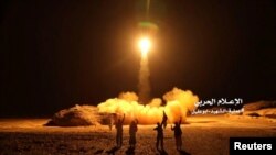 FILE - A photo distributed by the Houthi Military Media Unit shows the launch by Houthi forces of a ballistic missile aimed at Saudi Arabia, March 25, 2018. The Houthis said Wednesday they launched a ballistic missile at a Saudi National Guard camp near the border city of Najran.
