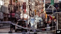 Police officers investigate the scene of an attack in New York's Chinatown neighborhood, Oct. 5, 2019.