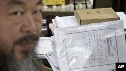 Artist Ai Weiwei with notice from city's Chaoyang District police that restrictions would expire Friday, Beijing, June 21, 2012.