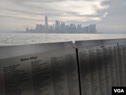 The names of 775,000 immigrants are memorialized across 770 panels that form the American Immigrant Wall of Honor, facing New York’s Lower Manhattan skyline. (R. Taylor/VOA)