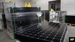 FILE - SunPower solar panels are stacked in Positive Energy Solar's warehouse in Albuquerque, New Mexico, March 9, 2016. The United States spent over $11 billion on issues related to climate change in 2014, according to U.S. goverment data.