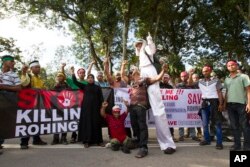 FILE - Myanmar ethnic Rohingya Muslims shout slogans during a protest against the persecution of Rohingya Muslims in Myanmar, in Kuala Lumpur, Malaysia, Dec. 4, 2016.