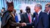 Wakil Presiden Republik Federal Nigeria Kashim Shettima, kiri, dan Presiden Rusia Vladimir Putin berjabat tangan setelah sesi pleno di KTT Afrika Rusia di St. Petersburg, Rusia, Jumat, 28 Juli 2023. (Mikhail Metzel/TASS Agen via AP)