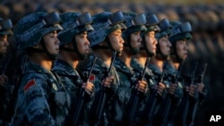 FILE - Soldiers of China's People Liberation Army (PLA) stand in line in front of Tiananmen Gate ahead of a military parade to commemorate the 70th anniversary of the end of World War II in Beijing.