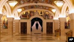 Sveštenik odlazi nakon liturgije bez prisustva vernika tokom epidemije koronavirusa u Hramu svetog Save u Beogradu, 19. aprila 2020. (AP Photo/Darko Vojinović)