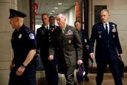 FILE - Joint Chiefs Chairman Gen. Joseph Dunford, center, walks to a classified briefing for members of the U.S. Senate on Iran, on Capitol Hill in Washington, May 21, 2019.