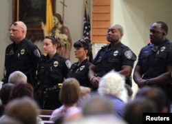 Police officers attend a church service after a fatal shooting of Baton Rouge policemen, at Saint John the Baptist Church in Zachary, Louisiana, July 17, 2016.