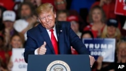 President Donald Trump gestures to the audience during his address on a number of topics, including his administration's successes and poking fun at his critics, during a Keep America Great Rally in Tupelo, Miss., Nov. 1, 2019.