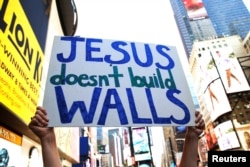 Interfaith religious leaders protest against Republican U.S. presidential candidate Donald Trump outside a hotel where he was to meet with evangelical leaders in New York City, June 21, 2016.