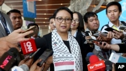 Wearing a Palestinian scarf, Indonesian Foreign Minister Retno Marsudi, center, talks to the media during Bali Democracy Forum held in Tangerang on the outskirts of Jakarta, Indonesia, Thursday, Dec. 7, 2017. Marsudi condemned the U.S. recognition of Jerusalem as the capital of Israel in her speech at the opening of the forum.