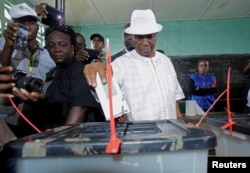 FILE - Joseph Nyuma Boakai, Liberia's vice president and presidential candidate of Unity Party (UP), votes at a polling station in Monrovia, Liberia