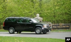 FILE - A motorcade SUV transporting President Donald Trump leaves the Trump National Golf Club in Bedminster, N.J., May 7, 2017.