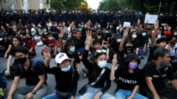Pro-democracy demonstrators flash a three-finger salute while sitting on the ground during a Thai anti-government mass protest, on the 47th anniversary of the 1973 student uprising, in Bangkok, Thailand October 14, 2020. REUTERS/Soe Zeya Tun